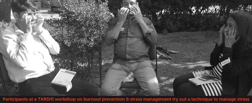Participants at a TARSHI workshop of burnout prevention and stree management try out a technique to manage stress