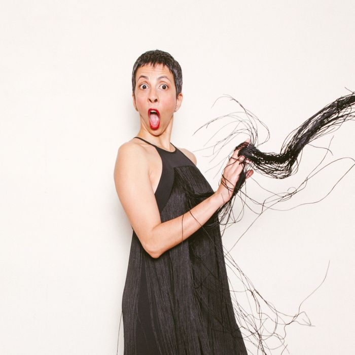 Photo of Radhika Vaz in a black flapper dress against a white background