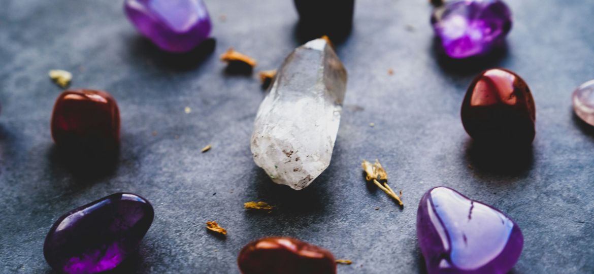 Close-up of purple and white heart shaped stones lying on the floor.