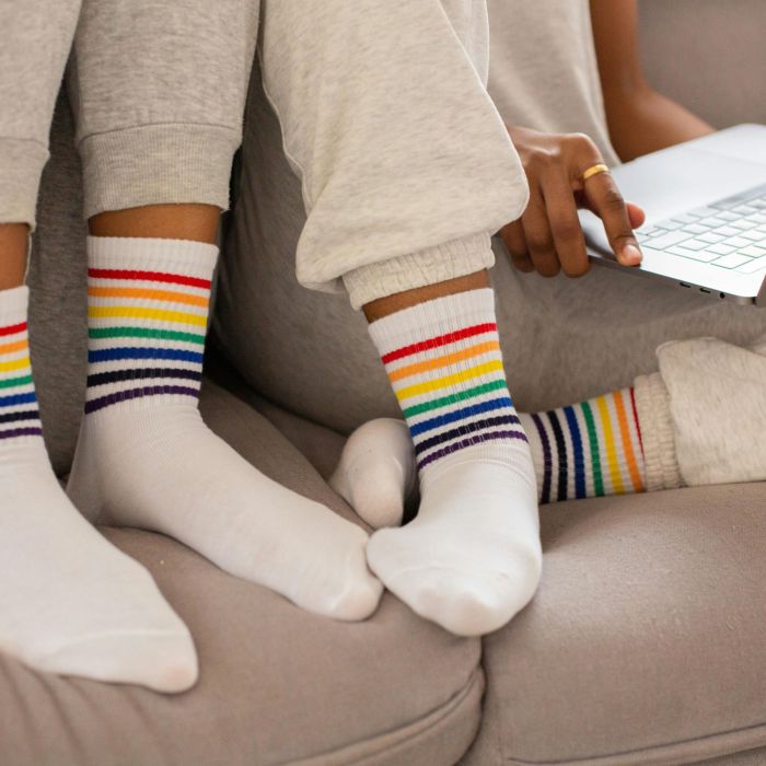 Close-up Photo of People wearing Pride Colored Socks.