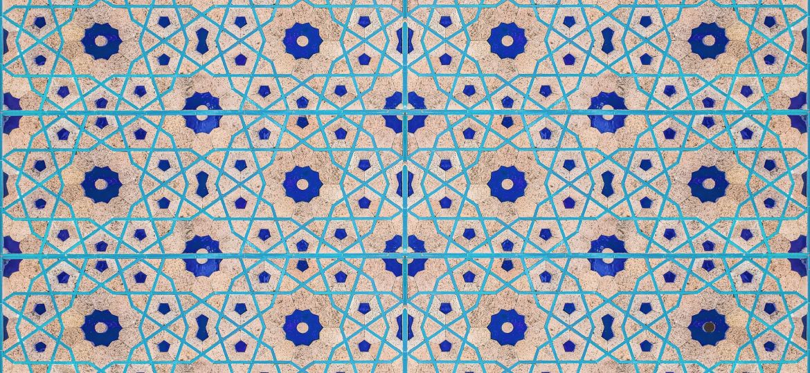 A blue and pink ceramic tile pattern on an off-white background.