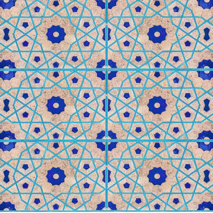 A blue and pink ceramic tile pattern on an off-white background.